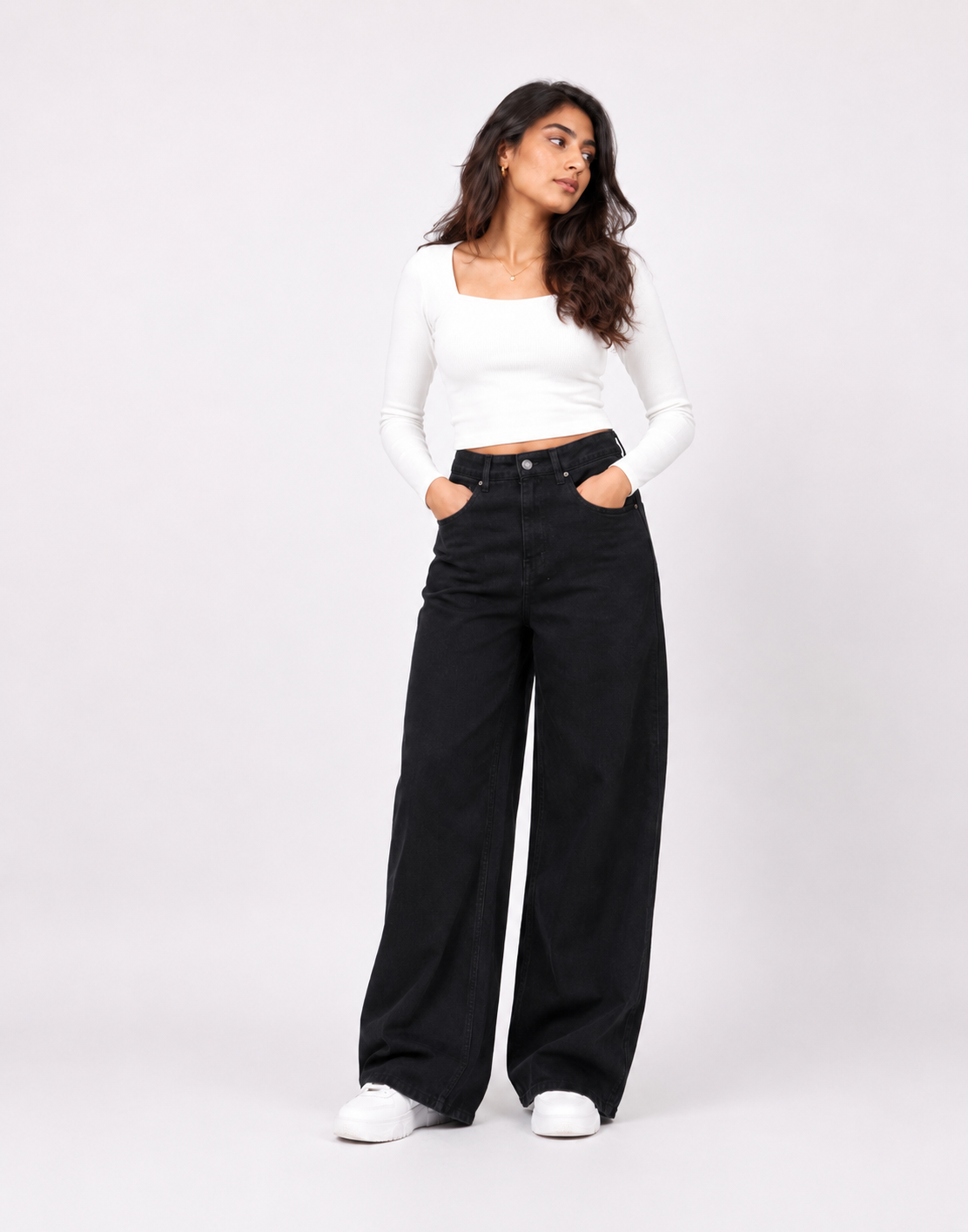 Aquila black wide-leg jeans paired with a white long-sleeved top
