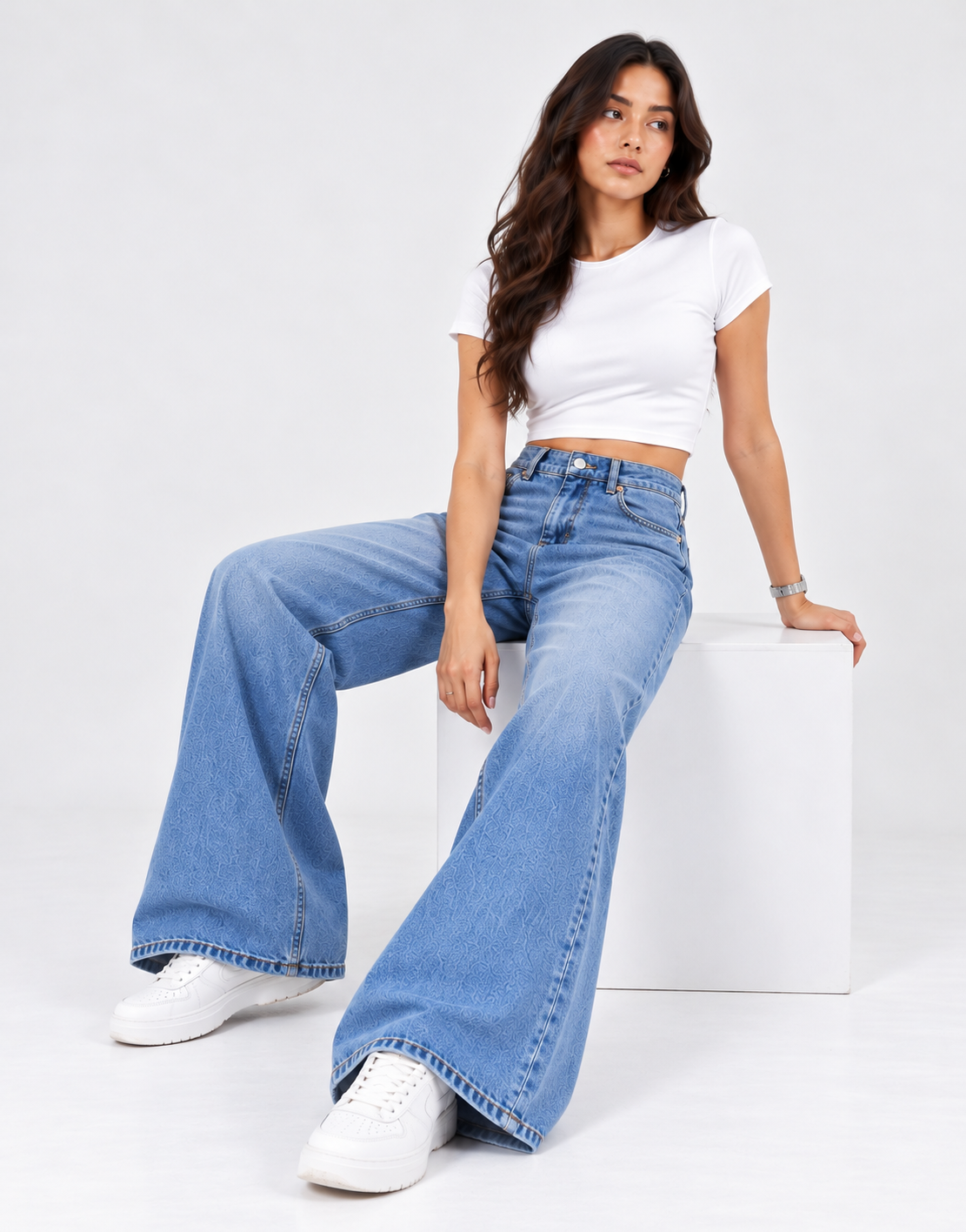 Faded mid-blue wide-leg jeans styled with a white top