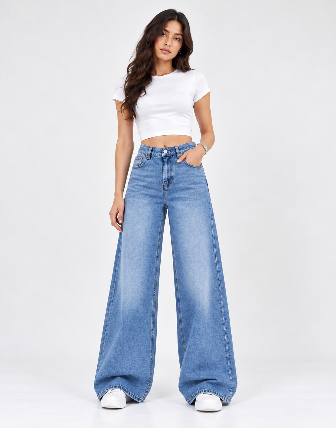 Front view of faded mid-blue wide-leg jeans styled with a white top