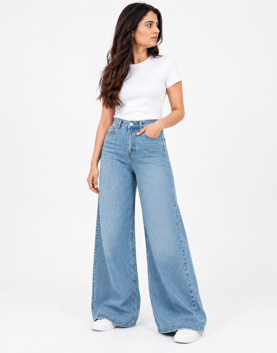 Angled front pose of faded mid-blue wide-leg jeans