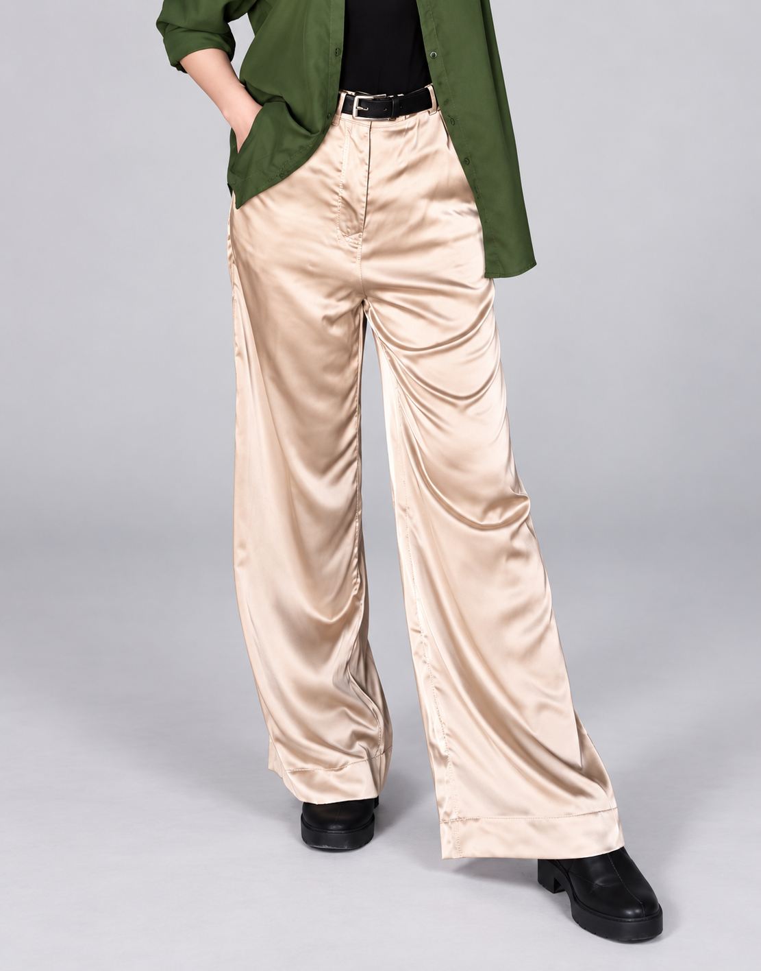 Closer view of the waistband, pockets and drape of beige wide-leg pants