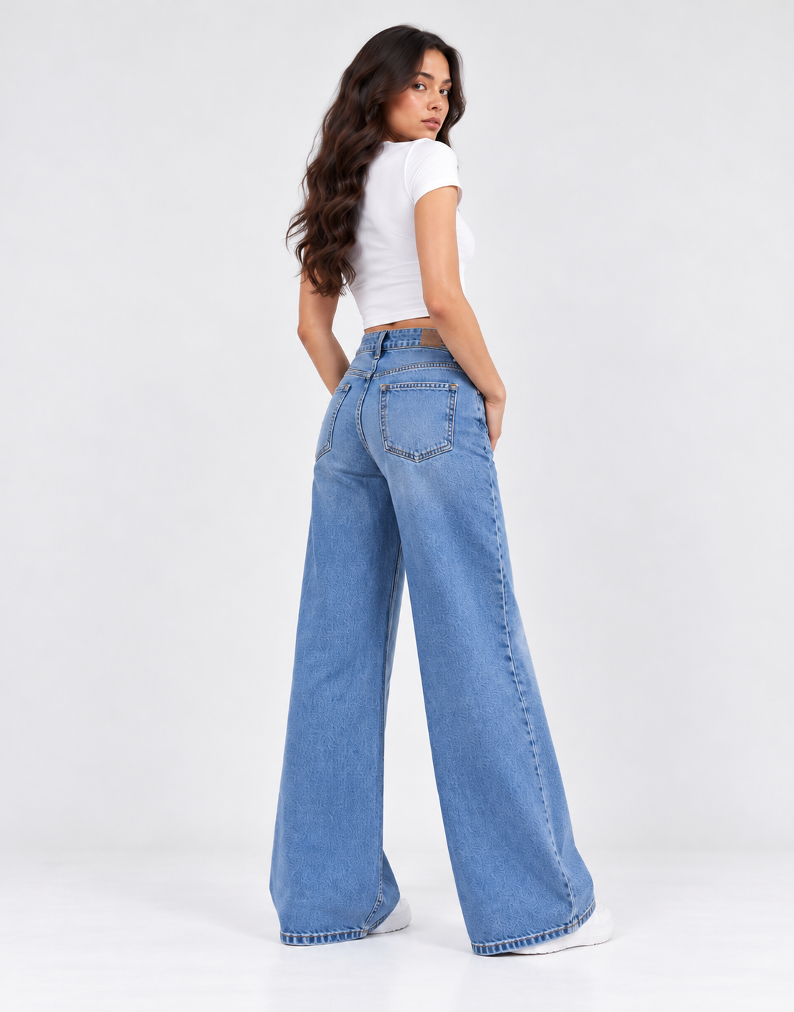 Back view of faded mid-blue wide-leg jeans showing the rear pockets